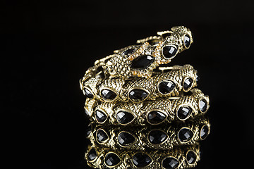 Image showing golden bracelet form of snake isolated black background