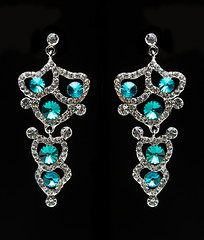 Image showing earrings with blue stones on the black 