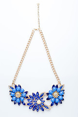 Image showing plastic necklace. three blue flower