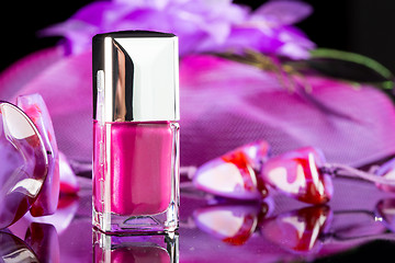 Image showing magenta nail polish on  background of women\'s accessories