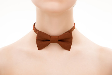 Image showing brown tie bow on female neck. 