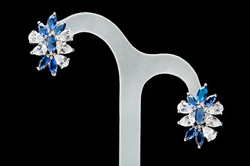 Image showing earrings with blue stones on the black 