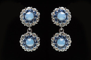 Image showing earrings with blue stones on the black 