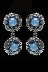 Image showing earrings with blue stones on the black 