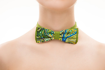 Image showing patterned tie bow on female neck. 