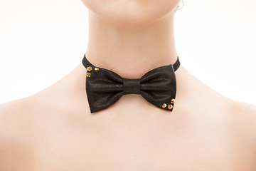 Image showing black tie bow on female neck. 