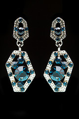 Image showing earrings with blue stones on the black 