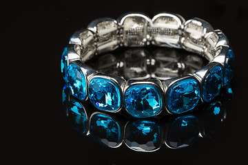 Image showing Bracelet with blue stones over black 