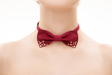 Image showing red tie bow on female neck. 