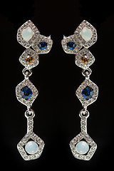 Image showing earrings with blue stones on the black 