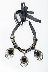 Image showing black necklace with stones on white 