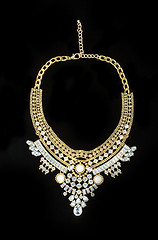 Image showing metal feminine necklace. on black  background. 