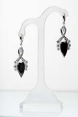 Image showing earrings with black stones on the white