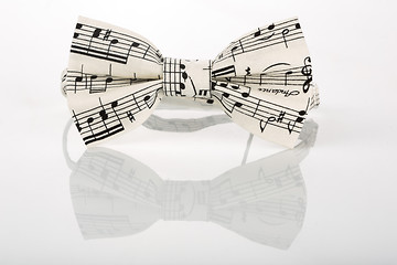 Image showing white bow tie with notes on a white background 