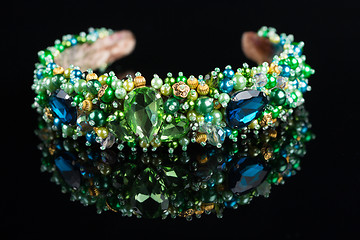 Image showing diadem with large green stones. bijouterie. on black background