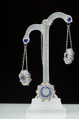 Image showing earrings with blue stones on the black 