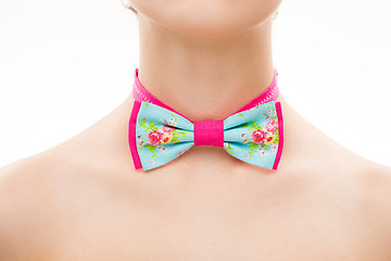 Image showing patterned tie bow on female neck. 