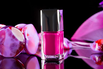 Image showing magenta nail polish on  background of women\'s accessories