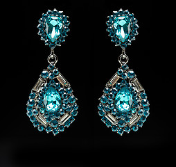 Image showing earrings with blue stones on the black 