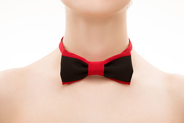 Image showing red  black tie bow on female neck. 
