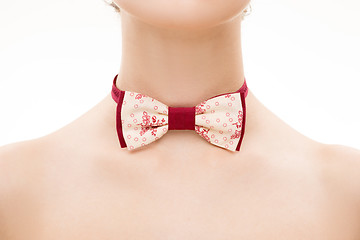 Image showing patterned tie bow on female neck. 