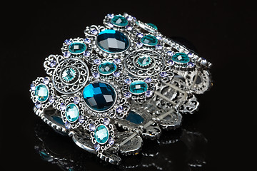 Image showing Bracelet with blue stones over black 