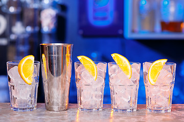 Image showing Glasses with ice cubes on wooden table