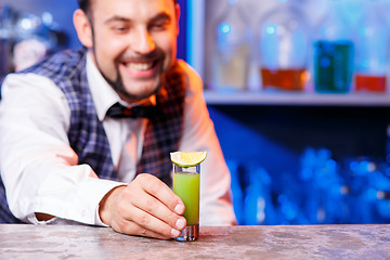 Image showing Barman at work, preparing cocktails.