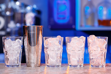 Image showing Glasses with ice cubes on wooden table