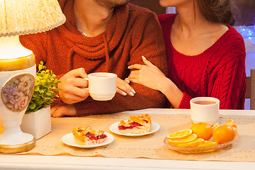 Image showing The  happy young couple with cups of tea 