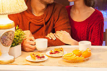 Image showing The  happy young couple with cups of tea 