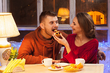 Image showing The  happy young couple with cups of tea 