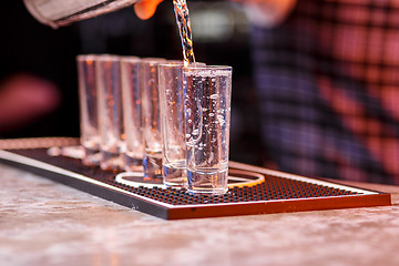 Image showing Barman at work, preparing cocktails.