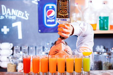 Image showing Bar Poplavok, Dnepropetrovsk, Ukraine - December 23, 2015: The barman at work, he preparing cocktails