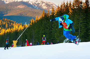 Image showing Snowboarder jumping at ski resort