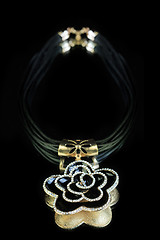 Image showing necklace. black flower