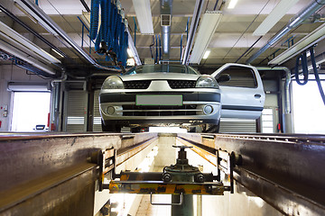 Image showing Car on service platform in garage.