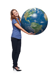 Image showing Woman in full length holding earth globe