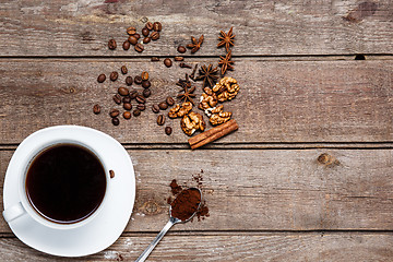 Image showing The cup of coffee on wooden table