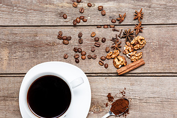 Image showing The cup of coffee on wooden table