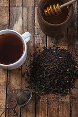 Image showing The cup of tea and honey on a wooden table