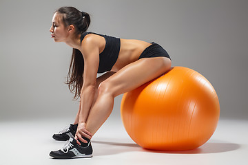 Image showing The young, beautiful, sports girl doing exercises on a fitball 