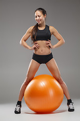 Image showing The young, beautiful, sports girl doing exercises on a fitball 