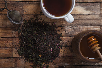 Image showing The cup of tea and honey on a wooden table