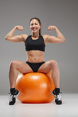 Image showing The young, beautiful, sports girl doing exercises on a fitball 