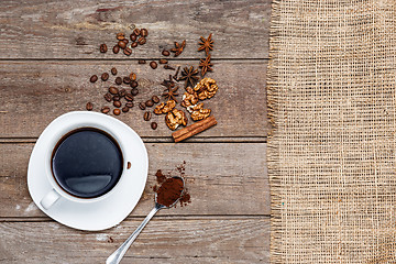 Image showing The cup of coffee on wooden table