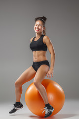 Image showing The young, beautiful, sports girl doing exercises on a fitball 