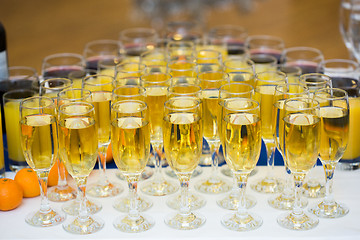 Image showing Glasses with champagne on the party table. lot of alcohol