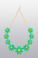 Image showing plastic necklace. five beige flower