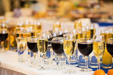 Image showing Glasses with champagne on the party table. lot of alcohol